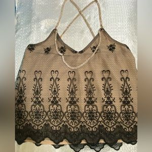 Sexy top in black and tan color with elegant details in the straps, Size M